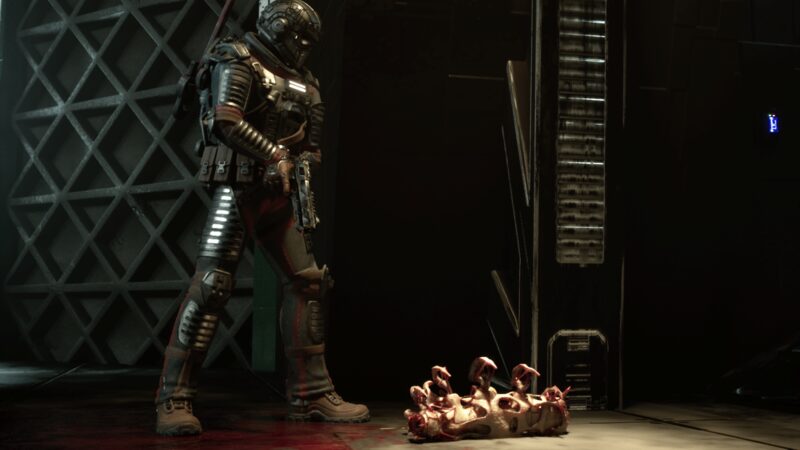 Colton standing over the carcass of a many-limbed parasite